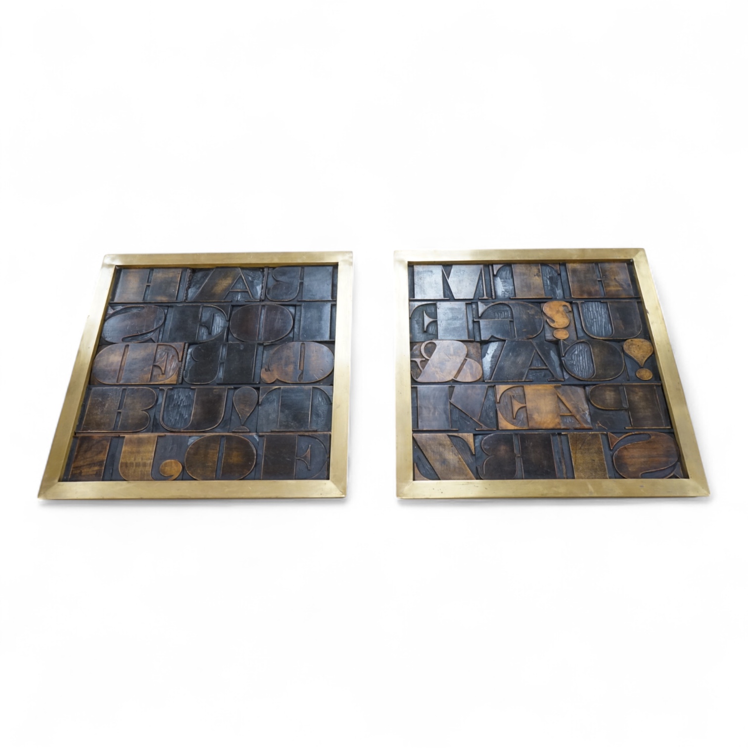 Two brass framed displays of printing blocks, 45cm sq